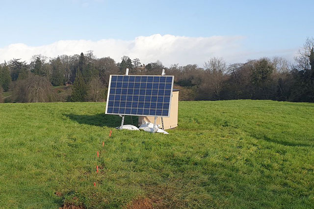 An array of solar panels in a field