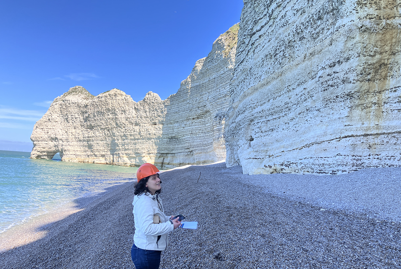 Dr Carole Nehme , University of Rouen examining the chalk cliffs at Étretat. BGS © UKRI 2025.